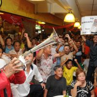 Happy bunnies: Workers' Party supporters celebrate as results for Singapore's Punggol East district by-election are announced Saturday evening. Candidate Lee Li Lian trounced the People's Action Party's candidate. Singapore's PAP loses by-election to Workers' Party