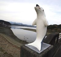 Sick symbol: A dolphin monument on the road in to the town of Taiji, Wakayama Prefecture, which strives to enrich its inhabitants by trumpeting the wonders of this species, while locals trap and spear thousands each year in the local coves. Dolphin 'crimes' exposed
