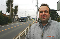 Australian Michael Laws stands at the spot of the accident in Saitama Prefecture that claimed the life of Patrick Alford. Dispute over police actions compounds traffic tragedy
