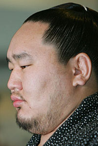 Sumo “bad boy” Asashoryu faces the cameras at Narita International Aiport last Wednesday before his flight back to Mongolia. The scapegoating of Asa