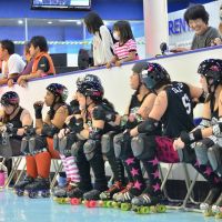 Ready to roll: The Yokota Scary Blossoms (above) watch teammates skate and await the next jam. Roller derby referees are also known as “Zebras.” The derby pack in position awaiting the approaching Scary Blossoms’ jammer. Roller derby dames get rough and tough on the rink