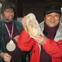 Have turnip will travel: Yoshio Otsuka (right) holds a rutabaga used in the 2011 International Rutabaga Curling Championship and kept frozen for a year, during his visit to Ithaca, New York, in late December. Turnip-tossing turns up trumps for trader