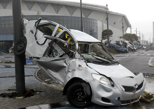 Writeoffs: Toyota Yaris sedans that were awaiting export to North America lie damaged at Sendai port on March 15. Supply-hit Nissan mulls partial shift of engine production to U.S.