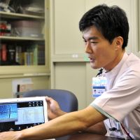 Spermed: Hideaki Kato displays an on-screen image of an artificial insemination during an interview at his office in Yokohama last June. Sperm donor offspring call for lifting veil of privacy