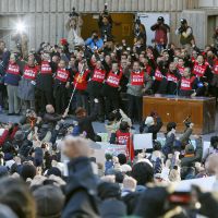 Out of range: People opposed to the deployment of the U.S. MV-22 Osprey in Okinawa punch the air Sunday in Tokyo's Hibiya district. Anti-Osprey rally in Tokyo draws thousands