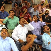 Best medicine: Indians take part in a session at a laughter club inspired by guru of giggling Madan Kataria in Greater Noida, on the outskirts of New Delhi, on Aug. 25. India's giggling guru counsels laughing yourself to good health
