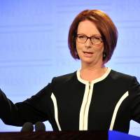 Looking ahead: Australian Prime Minister Julia Gillard speaks at the National Press Club in Canberra on Wednesday. On Saturday, three days after announcing that a general election will be held in September, two senior ministers bolted from her Cabinet. Gillard reshuffles Cabinet members