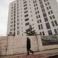 Hacker home?: A 12-story building alleged to be home to a Chinese military-led hacking group responsible for numerous cyber-attacks on the U.S. and other countries is seen in Shanghai's northern Gaoqiao suburb on Tuesday. Chinese military linked to widespread cyber-attacks