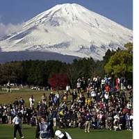 With Mount Fuji as a magnificent backdrop, David Duval of the United States exits a 2nd-hole bunker during the World Golf Championship-EMS World Cup played at the Taiheiyo Club in Gotemba, west of Tokyo, in November 2001. Golf: a sport that mirrors the nation