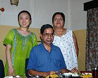 Emiko Dhar at home in Calcutta (top) with her husband, Sabitava, and a house guest who was voluneteering at Nirmal Hriday Mama Calcutta