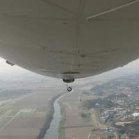 An in-flight view ahead from the passenger cubicle slung beneath the massive, 75-meter-long Zeppelin NT Up, up and away