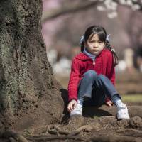 The 7-year-olds: Mayuko Takayanagi and Nozomu Hiramoto, are among 101 pairs of Tokyoites of every age from newborns to centenarians photographed by Petri Artturi Asikainen. Tracing time's passing through faces of Tokyo