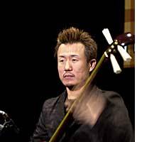 Shinichi Kinoshita looking stern as he concentrates hard during a rehearsal with his tsugaru shamisen at Ebisu Garden Hall in Tokyo. Tsugaru soul man