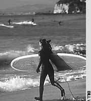 Surf’s up on a beach opposite Enoshima Enoshima: Kamakura's better half