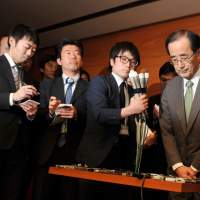 Resigned to his fate: Bank of Japan Gov. Masaaki Shirakawa speaks at BOJ headquarters in Tokyo on Tuesday night. Stocks soar on news of Shirakawa's early exit