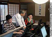 A student studying HTML interacts with his teacher at Nishijin Machiya Studio in Kyoto. 'Machiya' morphs into IT incubator