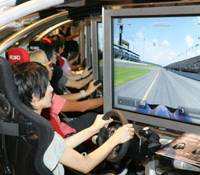 Visitors try the Sony PlayStation 3 (above) at the Tokyo Game Show 2007, in Makuhari, Chiba, on Sept. 20; others test out the Microsoft Xbox 360 at the game show; while one man photographs some of the models. Tokyo Game Show misses Nintendo
