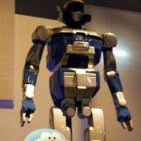 The HRP-2 robot developed by Japan’s National Institute of Advanced Industrial Science and Technology towers over Bandai’s Doraemon robot (above) at the National Museum of Nature and Science, Tokyo; Shobe Tamaya IX’s tea-serving karakuri clockwork doll (below) Japan traces robots' past, future