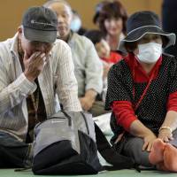 Just the beginning: Evacuees from the 20-km exclusion zone around Tokyo Electric Power Co.’s Fukushima No. 1 nuclear power station attend an event marking three months since the March 11 earthquake and tsunami, in Minamisoma, Fukushima Prefecture, on June 11, 2011. Evacuee suits target Tepco, government
