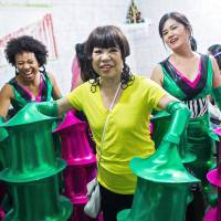 Last-minute alterations: Fashion designer Junko Koshino (center) displays the costumes she designed for the Barroca Zona Sul samba school in Sao Paulo on Feb. 6 during their last rehearsal before the Carnival. Junko Koshino lends style to Sao Paulo Carnival group