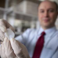 Plastic fantastic: Cornell University biomedical engineer Lawrence Bonassar holds the scaffolding for an ear his laboratory is creating using a 3-D printer and cartilage-producing cells on Feb. 13. Scientists use 3-D printing to help grow replacement ear