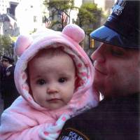 Emotive evidence: Gilberto Valle holds his daughter in a photo submitted as evidence on the opening day of his trial in New York on Monday. Gruesome details unveiled at 'Cannibal Cop' trial in New York