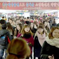 The blues: People walk through Gangnam subway station in Seoul. The rising of a nation
