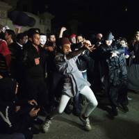Shakedown: Protesters do the “Harlem Shake” at the headquarters of the Muslim Brotherhood in Cairo. 'Harlem Shake' dance arrives on Egypt Islamists' doorstep