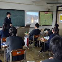 Distant learning: Junior high school students take a class at an ethnic Korean school in Yokohama, while an image of North Korea’s rocket launch is projected on a screen. Students convenient proxies in LDP's Pyongyang angst