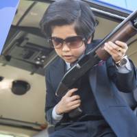 Playing with firepower: Eight-year-old actor Fuku Suzuki (playing Shigeru Ohnuma) wields a sawed-off shotgun in “Kodomo Keisatsu” (“Kiddy Cops”), a parody of popular 1970s Japanese cop shows. Kids with guns on film, blasting at the culture gap