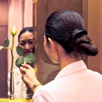 VIP service specialist Mina Tamaki, who changes the fresh rosebuds in the hotel's elevators thrice daily. Suites, treats and backstreets of the Imperial Hotel