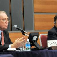 Murray McLean (left), Australia’s ambassador to Japan, speaks during the Sept. 27 symposium at Keidanren Kaikan in Tokyo while APEC Executive Director Muhamad Noor looks on. APEC needs to find growth amid new global landscape