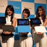 Model behavior: Microsoft Corp.’s Surface RT tablet computers and attachable keyboards are unveiled at a media event in Tokyo on Friday. Microsoft's tablet computer finally coming to Japan in search of sales