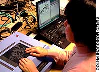 A blind woman uses a tactile display installed recently at the Osaka Prefectural Central Library. Library helps the blind enjoy graphics