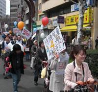 Taking it to the streets: Scores of people push baby strollers through the streets of Shibuya Ward, Tokyo, on April 5 in a march organized by nonprofit Fathering Japan to demand better day care facilities for preschoolers. Government day care falling short