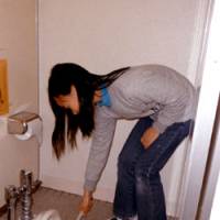 Tidy bowl: A girl cleans a toilet at Minami Elementary School in Yokohama on Dec. 1. Lavatory scrub joins kids' curricula