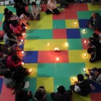 Supporting each other: Children orphaned by the March 11, 2011, disasters attend a one-day counseling program provided by the nonprofit group Ashinaga in Ishinomaki, Miyagi Prefecture, last November. Orphans need special trauma care