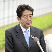 Doing the rounds: Prime Minister Shinzo Abe speaks to reporters Sunday in Koriyama, Fukushima Prefecture. Timeline for Okinawa land return in works