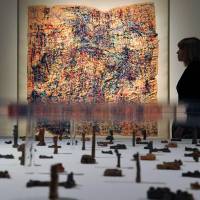 What's in a name?: A work titled Untitled by artist Komei Bekki is pictured in the foreground as an employee poses next to another artwork called Untitled by Satoshi Morita at the Wellcome Collection in central London on Wednesday. The works are part of the Souzou: Outsider Art from Japan exhibition. Japanese 'Outsiders' stage art exhibit in London