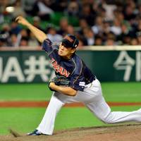 Early struggles: Team Japan right-hander Masahiro Tanaka, seen pitching against Cuba in the fourth inning of Wednesday’s WBC first-round game in Fukuoka, has yielded a run in his first inning of work in each of his last four games. Tanaka searching for consistency on mound