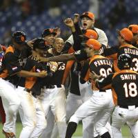 Dutch treat: Players from the Netherlands celebrate after their 7-6 sayonara victory over Cuba in their second-round game at the World Baseball Classic at Tokyo Dome on Monday night. Dutch shock Cuba to make WBC semifinals