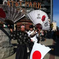 Samurai spirit: Japan supporter Shinjiro Suzuki (left) shows his colors before Sunday’s semifinal against Puerto Rico in San Francisco. Japan brings vibrant support to San Francisco