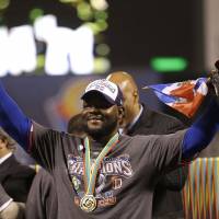 Bearing fruit: Dominican Republic reliever Fernando Rodney holds up a plantain as he celebrates his country’s 3-0 win over Puerto Rico in the final of the World Baseball Classic on Tuesday. Dominicans overcome by emotion after WBC victory