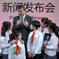 Global ambassador: David Beckham speaks during a promotional event at Shijia Primary School in Beijing on Wednesday. Beckham won't give timetable for retirement