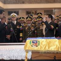 Transition of power: Venezuela’s Acting President Nicolas Maduro (left) holds a miniature copy of Venezuela’s constitution during a symbolic swearing-in ceremony in front of the late President Hugo Chavez’s coffin on March 8 in Caracas. There are many flavors to the Latin American left