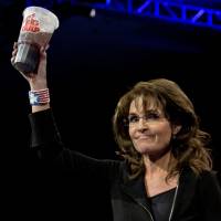 Sugar high: Former Alaska Gov. Sarah Palin holds up a 7-Eleven Super Big Gulp at the Conservative Political Action Conference in National Harbor, Maryland, on Saturday. Earlier in the week a New York judge struck down a ban proposed by New York City Mayor Michael Bloomberg to end the sale of sugared sodas larger than 16 oz. Republican divide deepens at conservative gathering