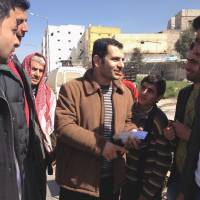 Outside the law: Supporters greet Dr. Othman al-Haj Othman on March 14 in Aleppo, Syria, after his release from the headquarters of a new authority that is trying to assert Islamic law. Othman was detained for taking down a poster bearing the Muslim declaration of faith. Left: Activist Wael Ibrahim, 30, was sentenced to 10 lashes with a small pipe last month for tossing aside an Islamic banner at a protest. Islamic law takes root in Syria's rebel-held territory