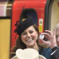 Badge of honor: Kate, the Duchess of Cambridge, receives a “Baby on Board” badge during a visit to London’s Baker Street station with Queen Elizabeth II on Wednesday. Pregnant Kate gets 'Baby on Board' pin for London Tube