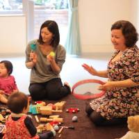 Tune time: Gillian Hudson Okuma leads a Music Together class. Watching moms get funky can get babies into the groove