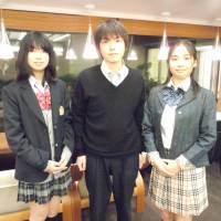 Change of dress: Three high school students wear their fake school uniforms in Minato Ward, Tokyo, on April 20. Fake school uniforms let some turn back the clock